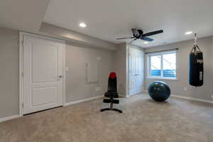 Workout area with light colored carpet, recessed lighting, and a ceiling fan