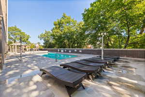 Community pool with a patio