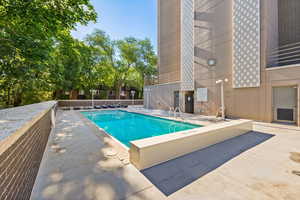 Community pool featuring a patio