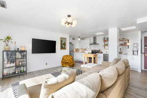 Living room featuring light wood-style floors and a chandelier