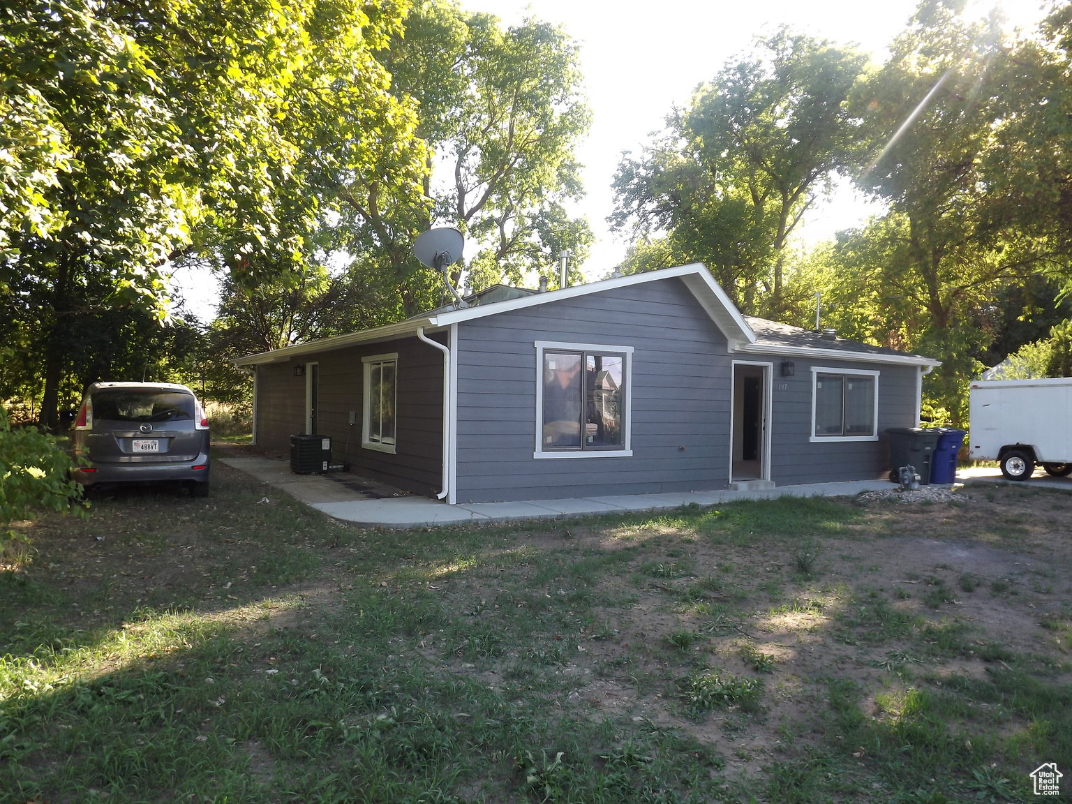 Front/side view of property with a yard