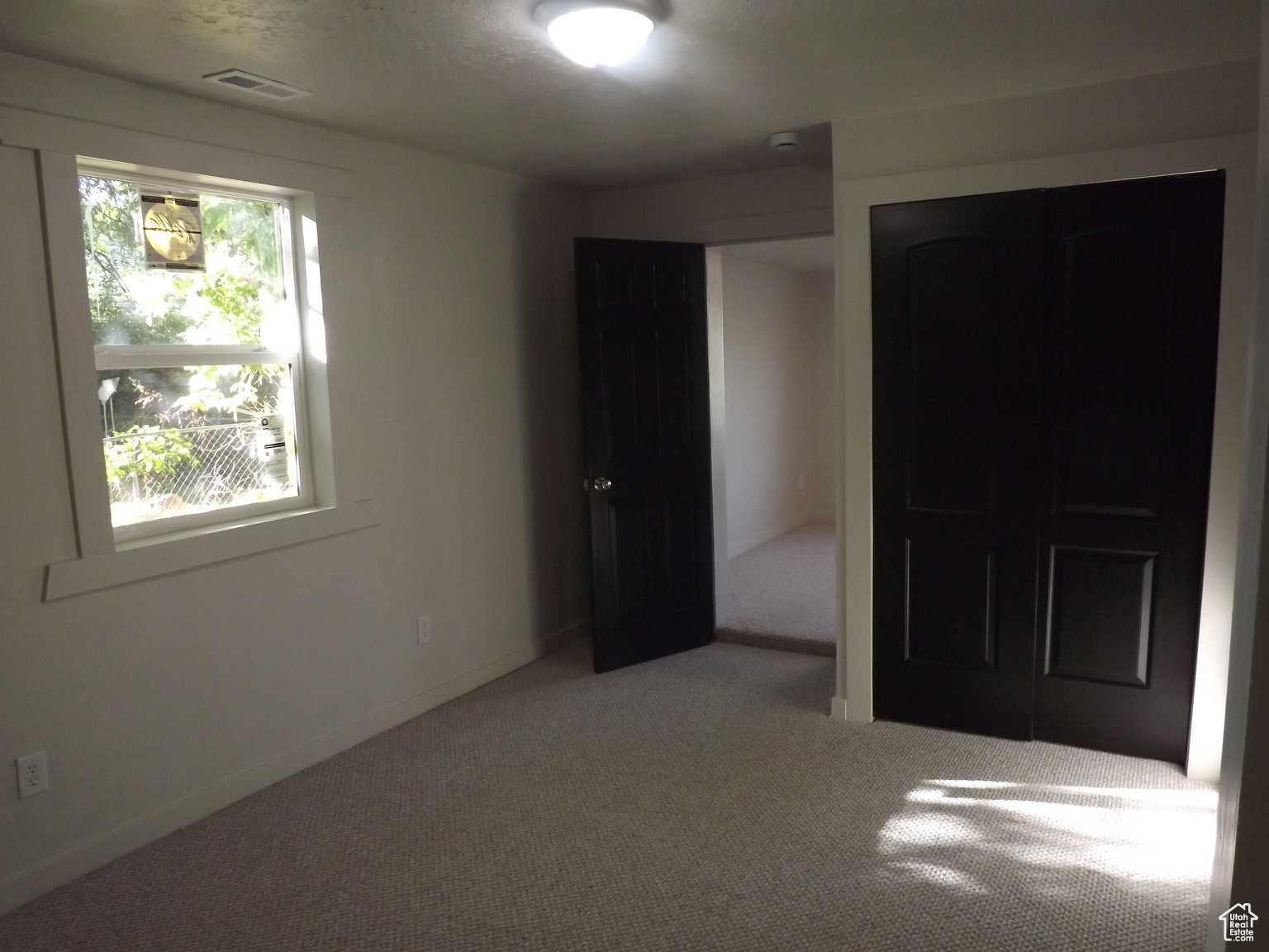 Bedroom with carpet and a closet