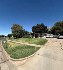 View of front of house with a front yard and driveway