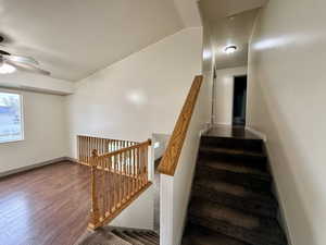 Stairway featuring wood finished floors and baseboards