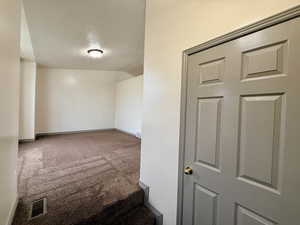 Spare room featuring carpet floors and a textured ceiling