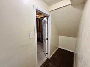 Corridor with a textured ceiling and a textured wall