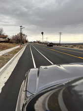 View of asphalt road featuring sidewalks