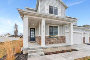 Beautiful home front showcasing minimalistic landscaping and covered front porch