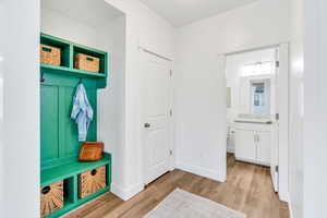 Mudroom with light wood finished floors