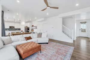 Great living room space including a coat closet, garage entrance, and staircase to upper level bedrooms