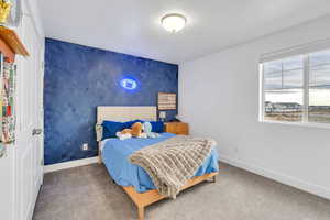 Featuring an accent wall in this spacious upstairs bedroom