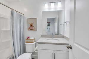 Airy bathroom furnished with vanity, and large tub
