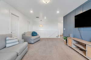 Lofted family room featuring a beautiful accent wall