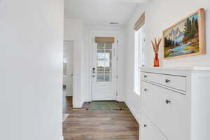 Entryway with wood finished floors and baseboards