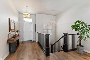 Foyer entrance featuring a chandelier and light wood finished floors