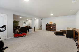 Exercise area with light colored carpet and recessed lighting