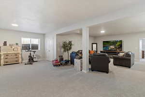 Carpeted living area featuring recessed lighting