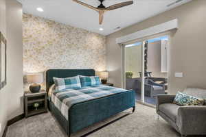 Carpeted bedroom with access to exterior, wallpapered walls, ceiling fan, recessed lighting, and an accent wall