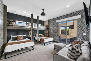 Bedroom with access to outside, wallpapered walls, carpet floors, and recessed lighting