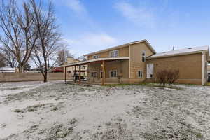 Snow covered property with a patio area
