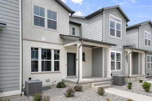 View of front of home with a porch and brick siding