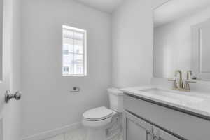 Bathroom featuring vanity and light marble finish floors