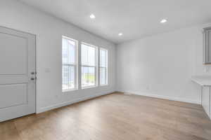 Foyer with light wood-style flooring and recessed lighting