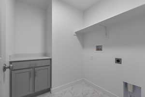 Laundry room with light marble finish floors, washer hookup, and electric dryer hookup