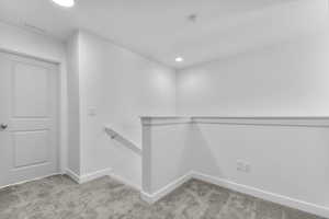 Spacious closet with light carpet