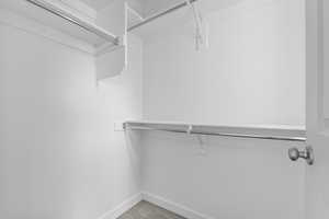 Walk in closet with light carpet