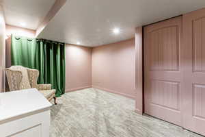 Unfurnished room with light colored carpet and recessed lighting