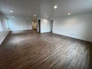 Unfurnished room featuring dark wood-style flooring and recessed lighting