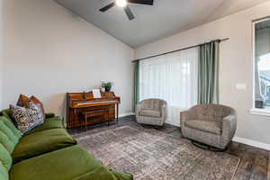 Living room featuring lofted ceiling, wood finished floors, healthy amount of natural light, and ceiling fan