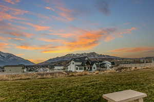 Back of property featuring a mountain view and a patio area