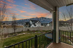 Balcony at dusk with a mountain view and a residential view