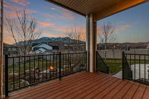 Deck at dusk featuring a mountain view