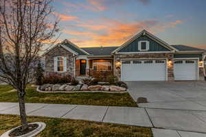 Craftsman-style home with board and batten siding, a porch, concrete driveway, an attached garage, and a front yard