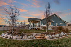 Back of house with a trampoline and a patio