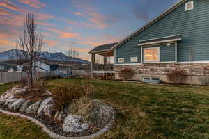 View of home's exterior featuring stone siding, a sunroom, and a mountain view