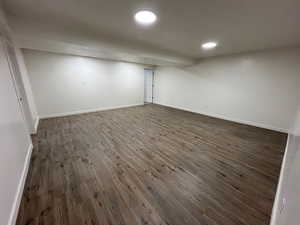 Finished basement with dark wood-type flooring and recessed lighting
