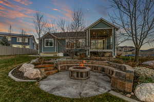 Rear view of property with a patio area, a trampoline, a fire pit, and a balcony