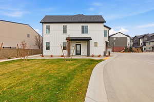 View of front facade with board and batten siding and roof with shingles