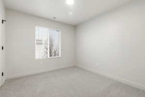 Unfurnished room with carpet and baseboards