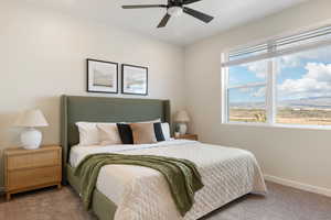 Carpeted bedroom with baseboards and ceiling fan