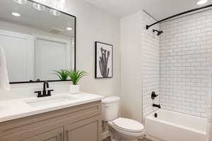 Full bath featuring vanity, washtub / shower combination, and recessed lighting