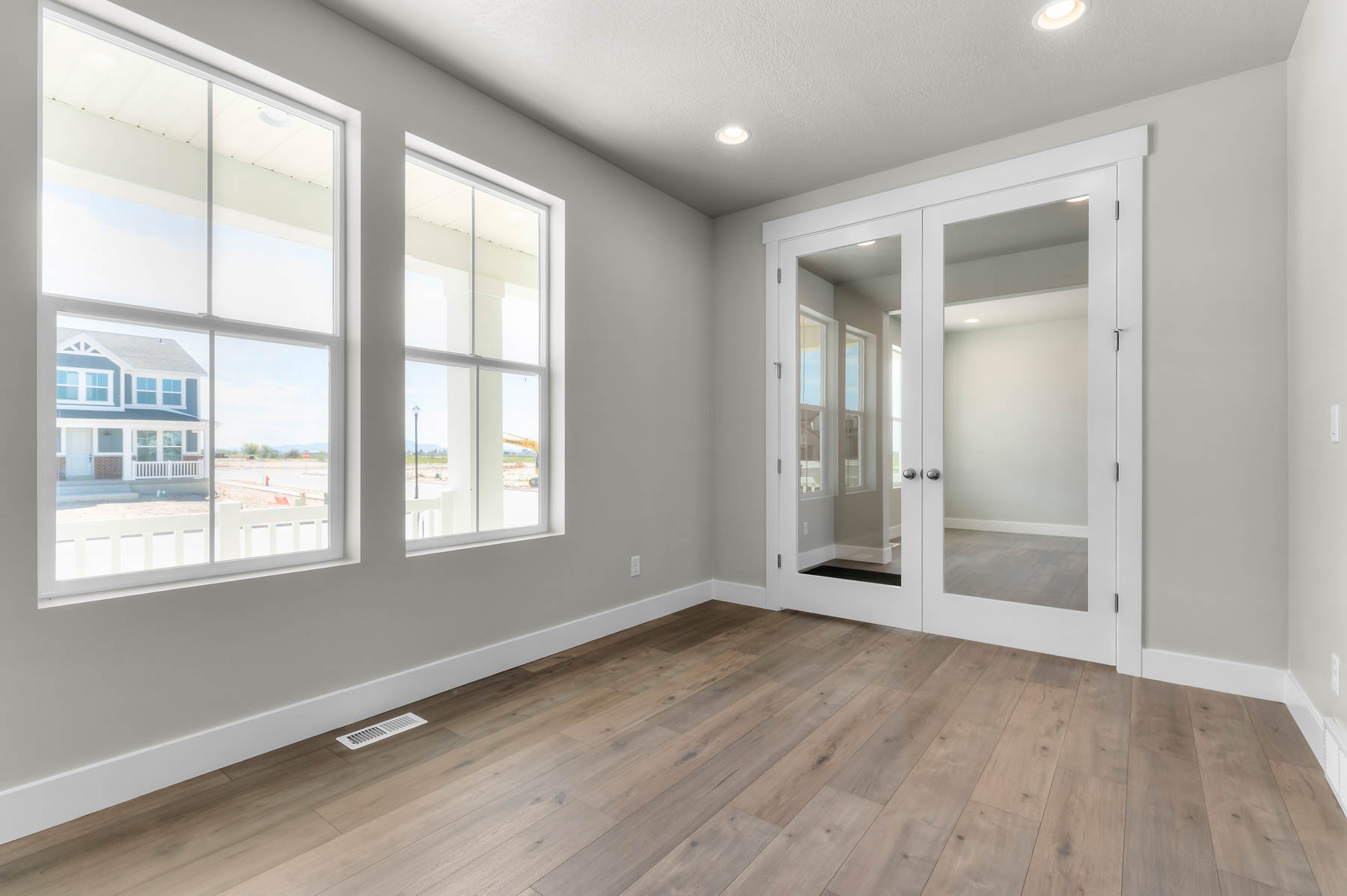 Unfurnished room with light wood-style flooring, french doors, and recessed lighting