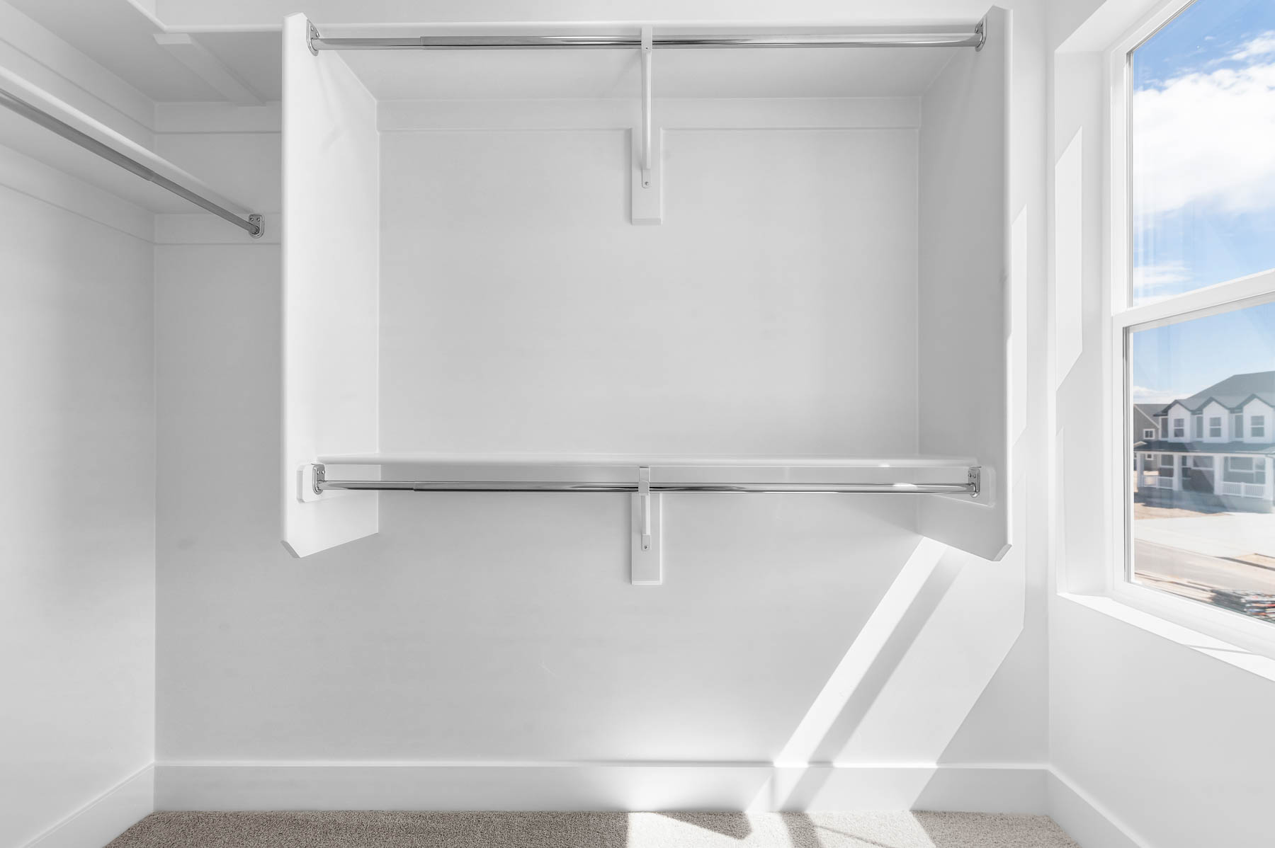Walk in closet with carpet floors