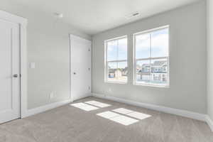 Unfurnished bedroom featuring baseboards and light colored carpet