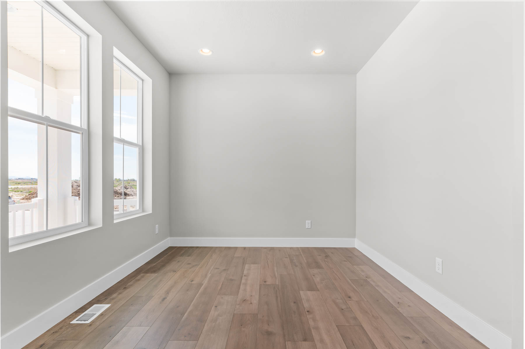 Empty room with light wood-type flooring and recessed lighting