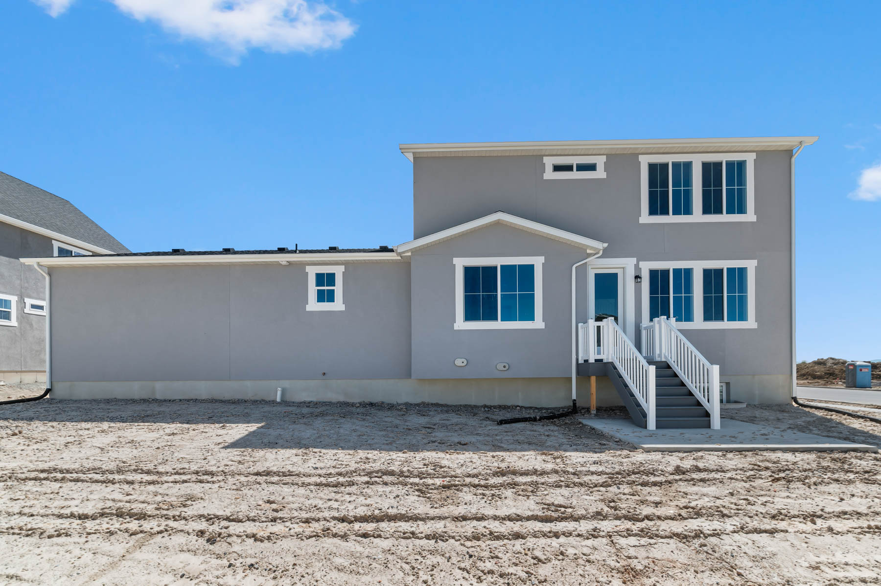 Back of property featuring stucco siding